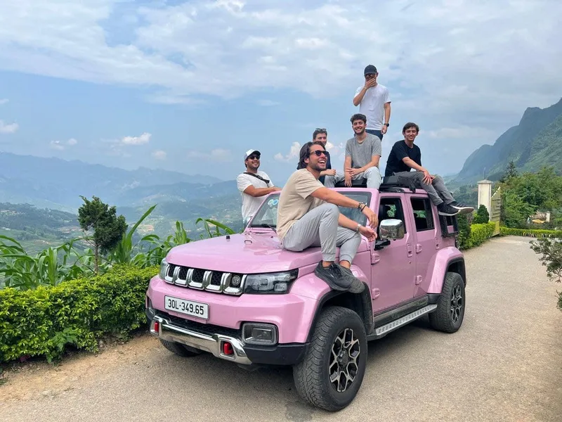 Tourist enjoying scenic view while using Ha Giang car rental with driver service